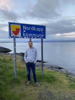 Paul poses at the Nordkapp kommune sign